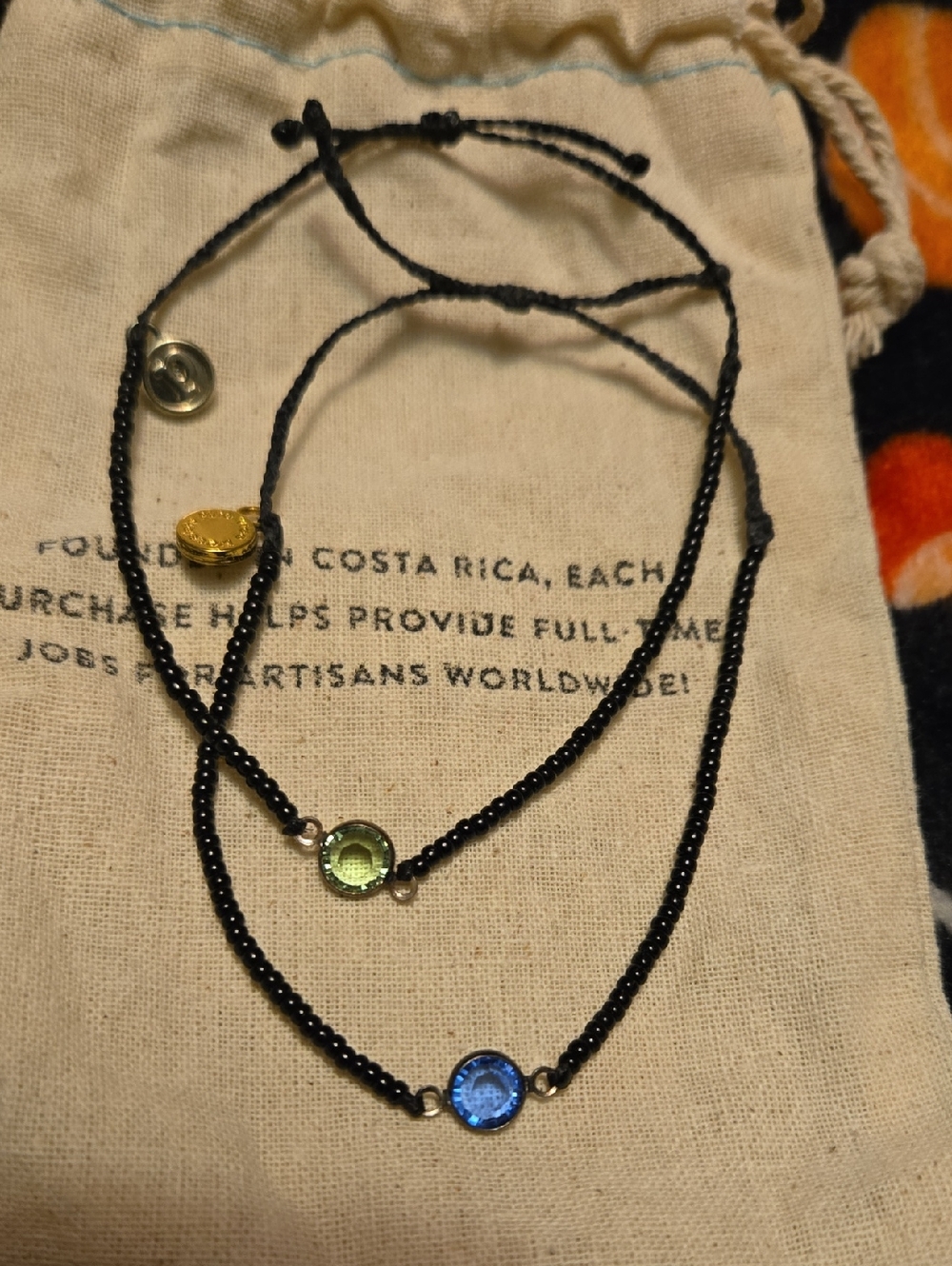 Pura Vida Black Beaded Bracelets with Blue and Green Gem Accents.